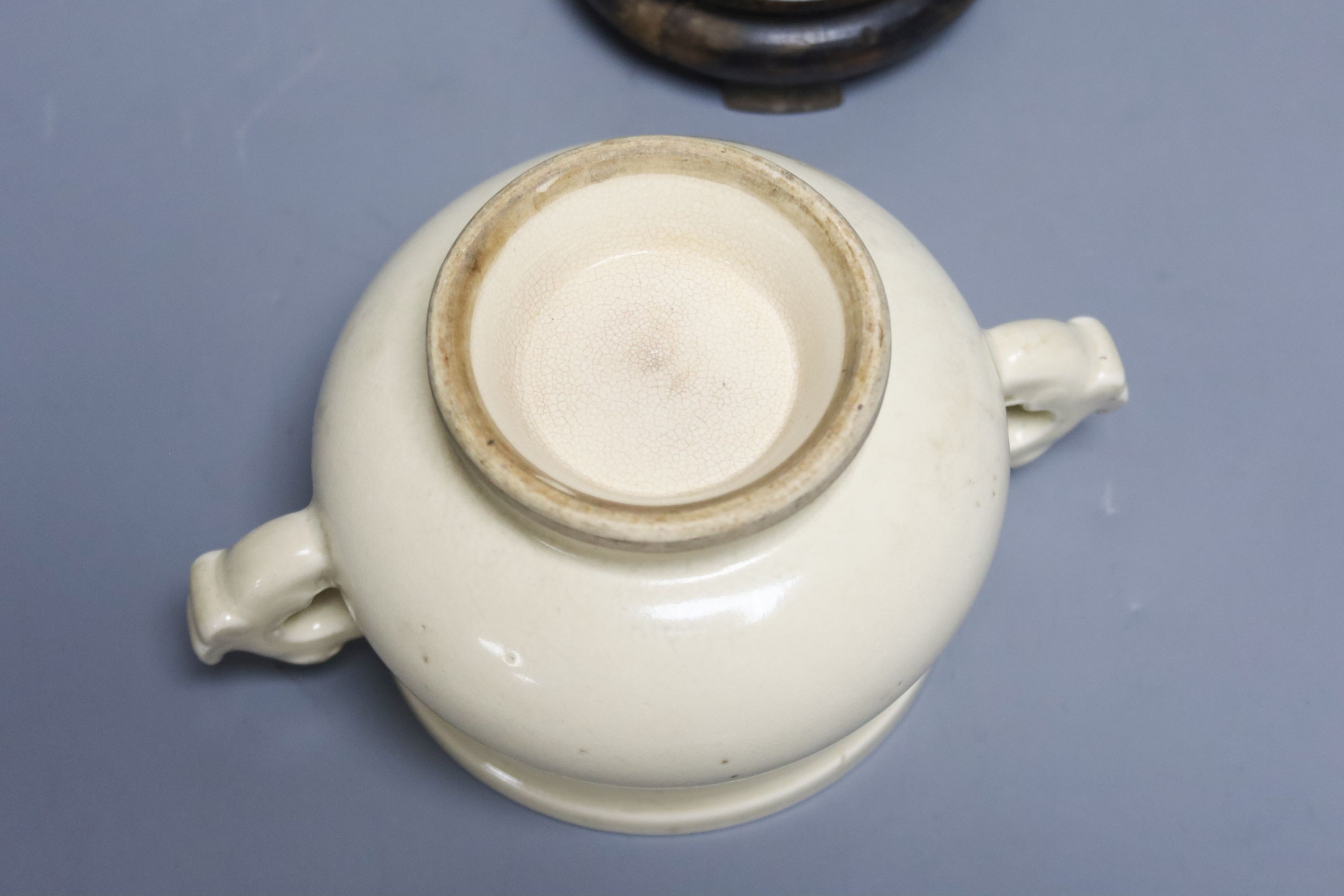 A Chinese cream crackle glazed censer, Qing dynasty, with dragon handles, 19 cm wide, on hardwood stand, W 18cm